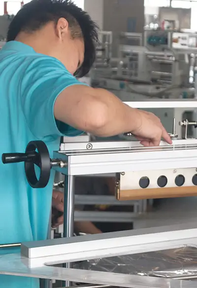 worker is assembling the shrink package machine