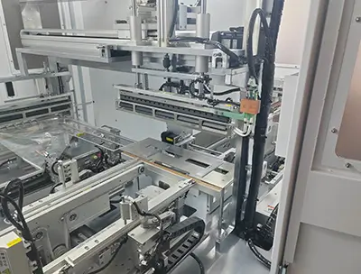 Close-up of key components inside the TY480 shrink-wrap machine, showing stainless-steel guides, pneumatic actuators, and precision conveyors (2)