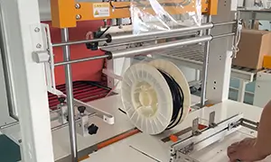 Shrink bundler for industrial products, including electrical coils